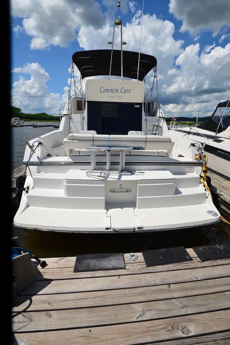 Slide: The Image of 1989 Carver Santego 3867 yacht docked under a cloudy sky. - 3