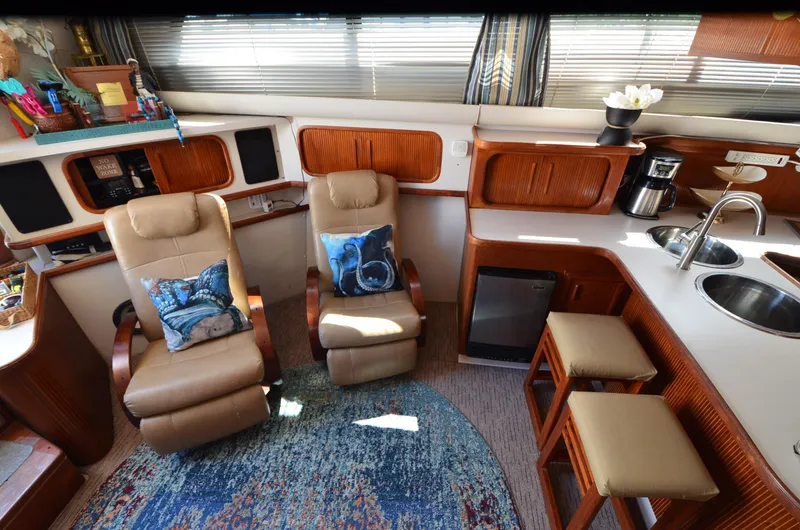 Slide: The Image of Interior of 1989 Carver Santego 3867 yacht with seating, kitchenette, and decor. - 31