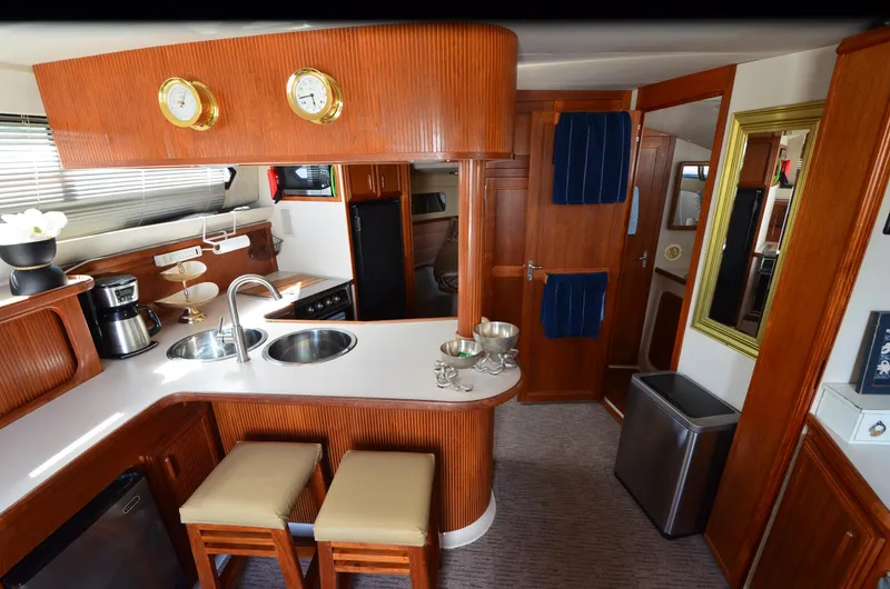 Slide: The Image of Interior of 1989 Carver Santego 3867 yacht with modern kitchen and wooden cabinetry. - 32
