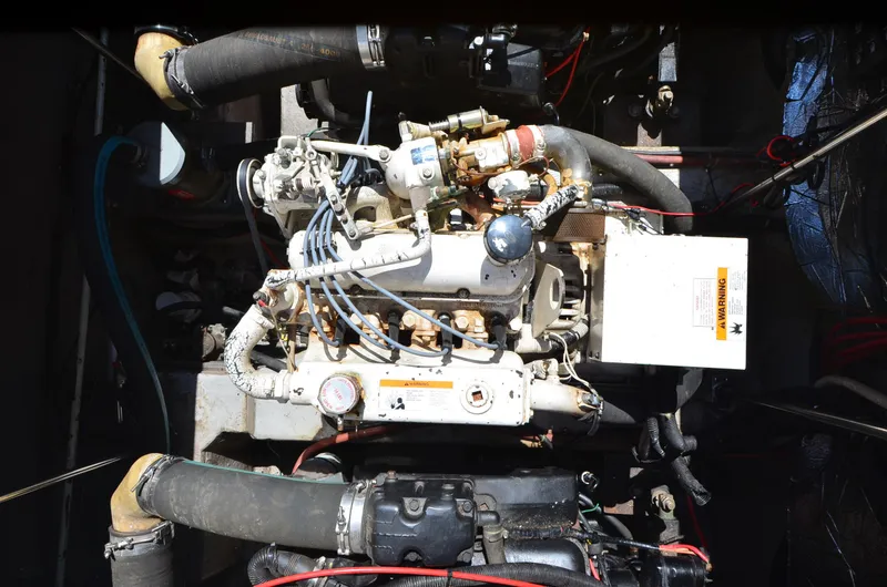 Slide: The Image of Engine compartment of a 1989 Carver Santego 3867 boat, showing detailed mechanical components. - 38