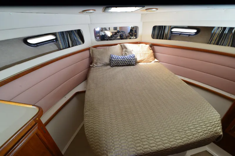 Slide: The Image of Cozy cabin interior of 1989 Carver Santego 3867 with a comfortable bed and porthole windows. - 7
