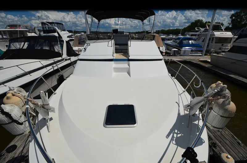 Slide: The Image of 1989 Carver Santego 3867 yacht docked at marina, surrounded by other boats. - 9