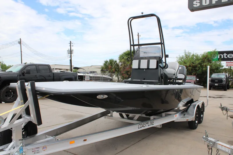 Slide: The Image of 2025 Freedom Boats 23' Warrior on trailer, parked outdoors, showcasing sleek design. - 24