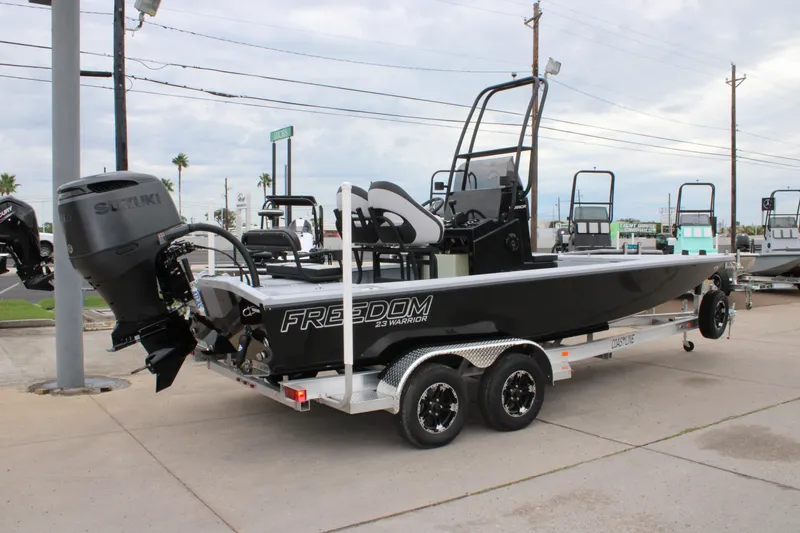 Slide: The Image of 2025 Freedom Boats 23' Warrior on trailer, featuring Suzuki outboard motor. - 25
