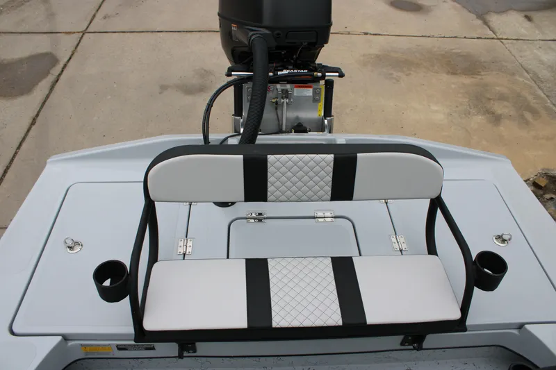 Slide: The Image of 2025 Freedom Boats 23' Warrior rear seating with cup holders and motor view. - 8