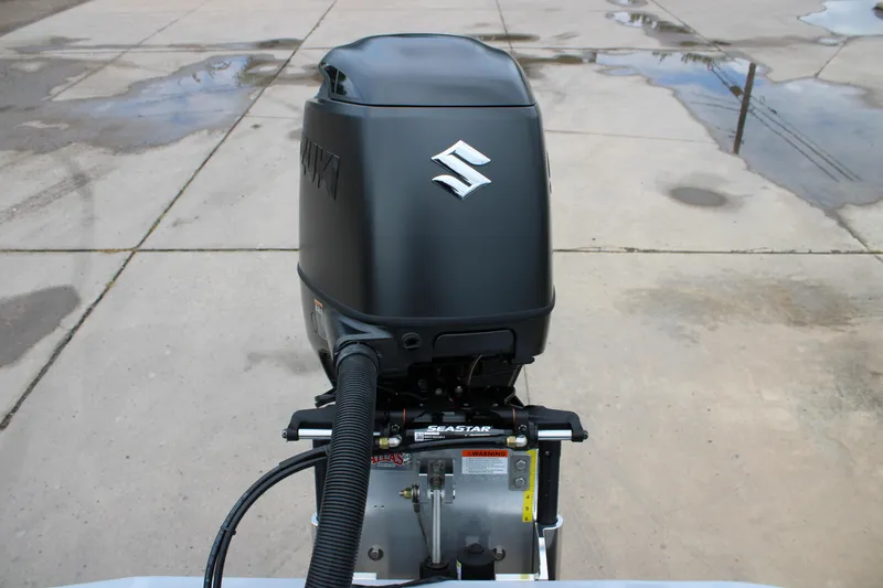 Slide: The Image of Outboard motor on 2025 Freedom Boats 23' Warrior, featuring Suzuki branding. - 9