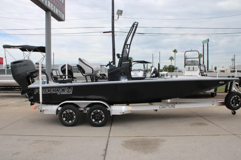 Slide: The Image of 2025 Freedom Boats 23' Warrior on trailer, featuring Suzuki outboard motor. - 1