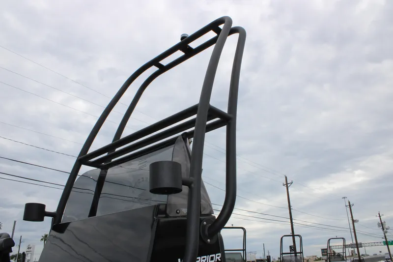 Slide: The Image of 2025 Freedom Boats 23' Warrior with sleek black frame against cloudy sky. - 13