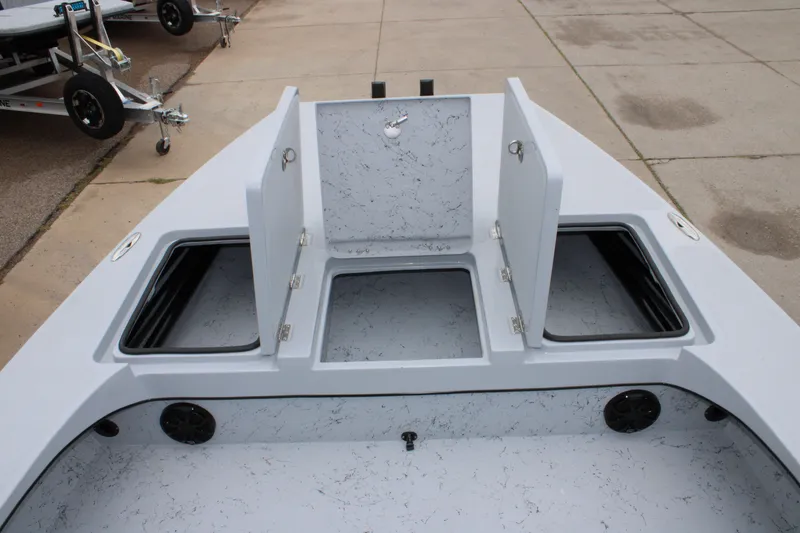 Slide: The Image of 2025 Freedom Boats 23' Warrior with open storage compartments on deck. - 15