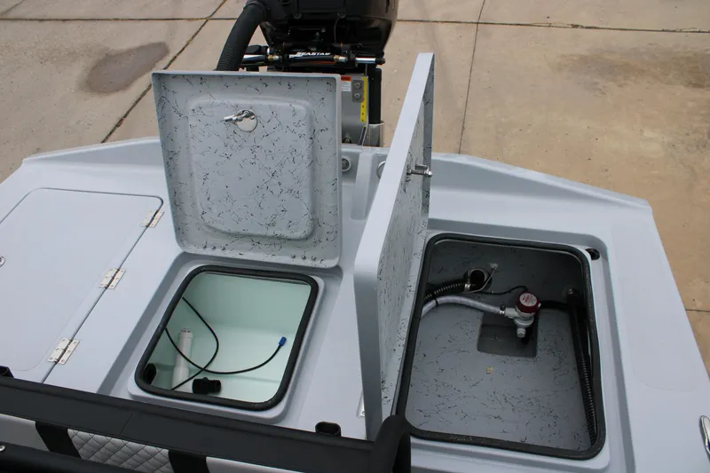 Slide: The Image of 2025 Freedom Boats 23' Warrior with open storage compartments and visible engine components. - 16