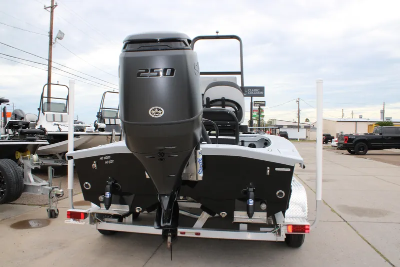 Slide: The Image of 2025 Freedom Boats 23' Warrior with 250 HP engine on trailer, rear view. - 26