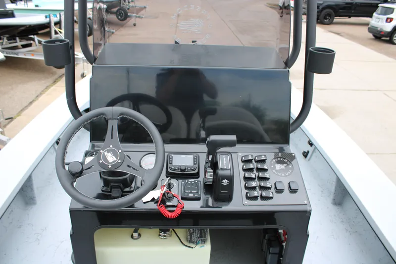 Slide: The Image of 2025 Freedom Boats 23' Warrior console with steering wheel and controls. - 3