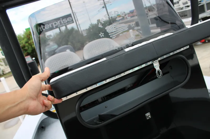 Slide: The Image of 2025 Freedom Boats 23' Warrior dashboard with hand adjusting windshield. - 4