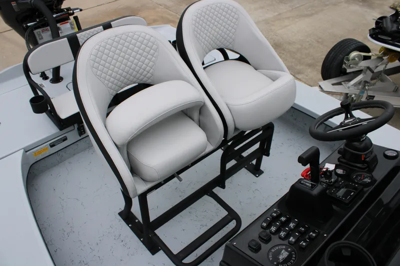 Slide: The Image of 2025 Freedom Boats 23' Warrior interior with white cushioned seats and control panel. - 5