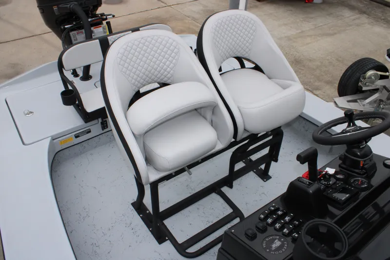 Slide: The Image of 2025 Freedom Boats 23' Warrior interior with dual white seats and control console. - 6