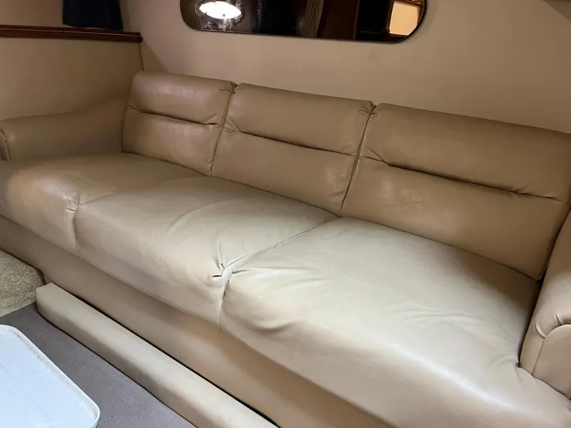 Slide: The Image of 2004 Cruisers Yachts 320 Express interior with beige leather seating. - 19