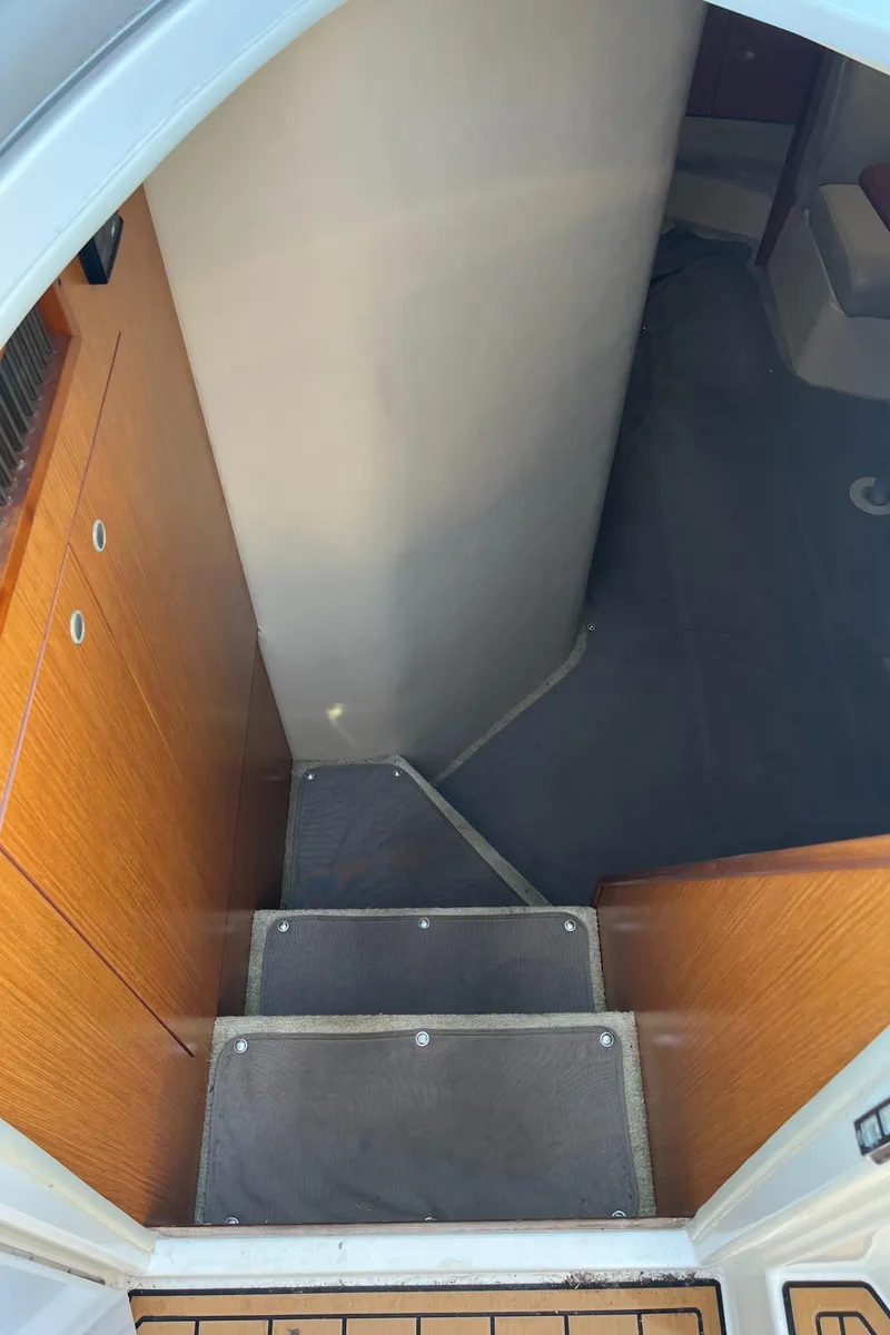 Slide: The Image of Stairway leading to cabin interior of 2004 Cruisers Yachts 320 Express. - 21