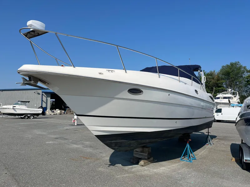 Slide: The Image of 2004 Cruisers Yachts 320 Express boat on stands in a marina. - 3