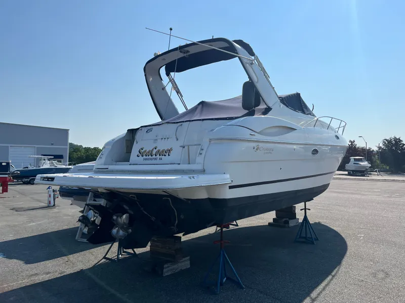 Slide: The Image of 2004 Cruisers Yachts 320 Express on stands in a boatyard, rear view. - 6