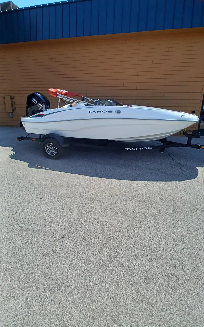 The Image of 2025 Tahoe T16 boat on trailer, parked outdoors, side view. - 0