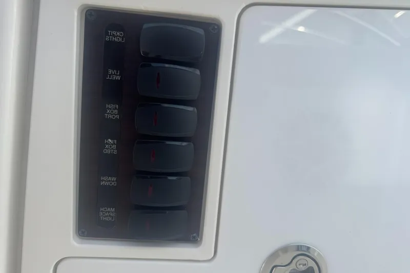 Slide: The Image of Control panel on 2024 Pursuit S 358 Sport boat with labeled switches. - 15