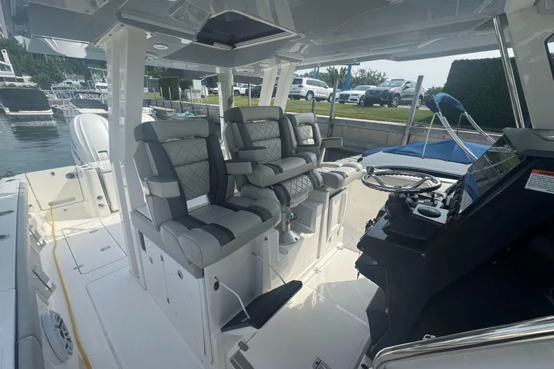 Slide: The Image of 2024 Pursuit S 358 Sport boat interior with luxurious seating and modern helm controls. - 16