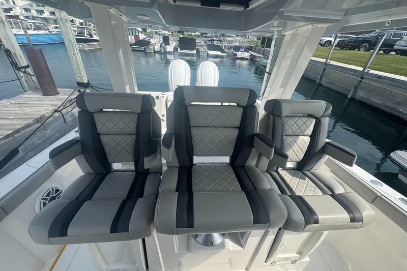 Slide: The Image of 2024 Pursuit S 358 Sport boat seats with quilted design at marina. - 17