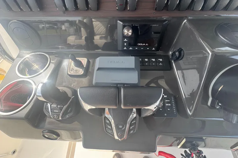 Slide: The Image of 2024 Pursuit S 358 Sport boat dashboard with controls and navigation system. - 19