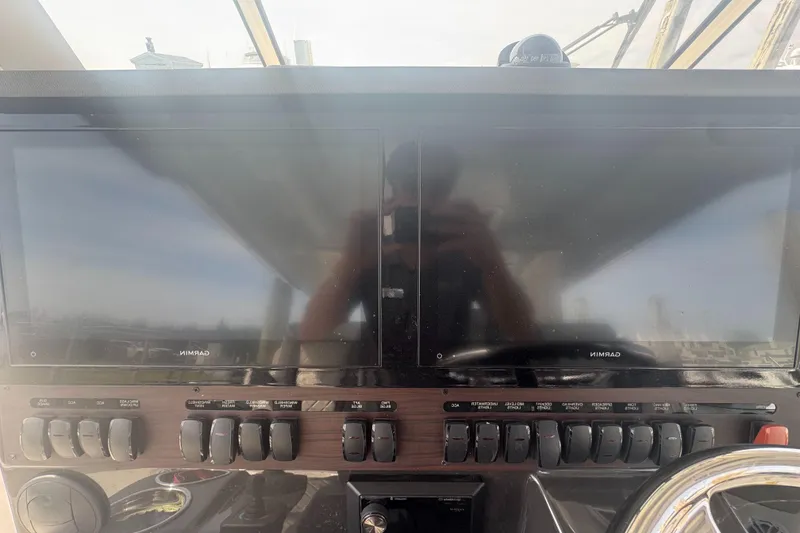 Slide: The Image of 2024 Pursuit S 358 Sport dashboard with dual Garmin displays and control switches. - 20