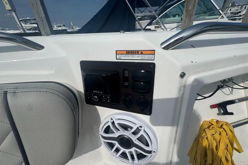 Slide: The Image of 2024 Pursuit S 358 Sport boat interior with audio controls and speaker. - 25