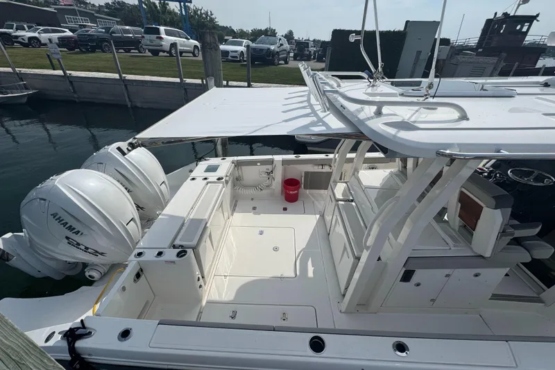 Slide: The Image of 2024 Pursuit S 358 Sport boat docked, featuring dual Yamaha engines and spacious deck. - 27