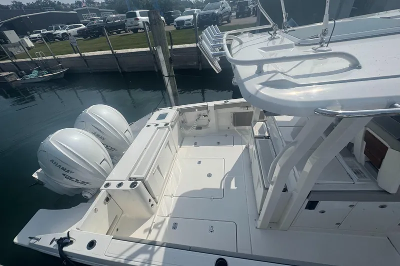 Slide: The Image of 2024 Pursuit S 358 Sport boat with dual Yamaha engines docked at marina. - 3