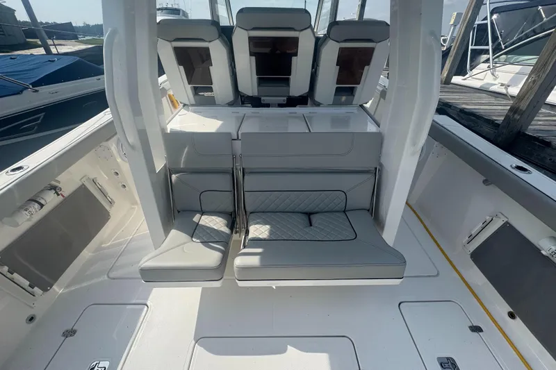 Slide: The Image of 2024 Pursuit S 358 Sport boat interior with cushioned seating and modern design. - 5