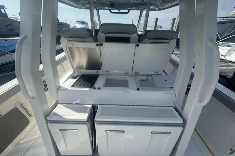 Slide: The Image of 2024 Pursuit S 358 Sport boat interior with seating and storage compartments. - 7