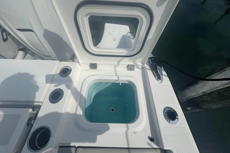Slide: The Image of 2024 Pursuit S 358 Sport boat livewell and storage compartment. - 9