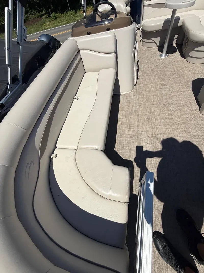 Slide: The Image of 2016 Bennington 22 SX boat interior with beige seating and steering console. - 11