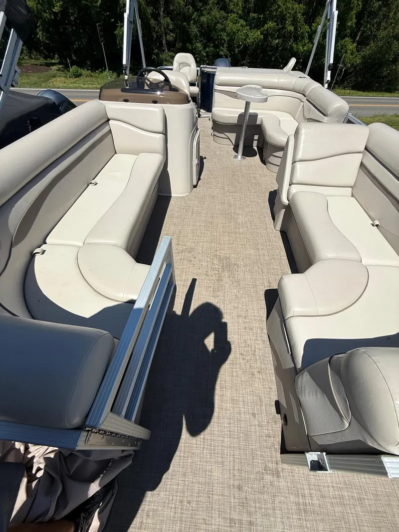 Slide: The Image of 2016 Bennington 22 SX pontoon boat interior with beige seating and steering console. - 13