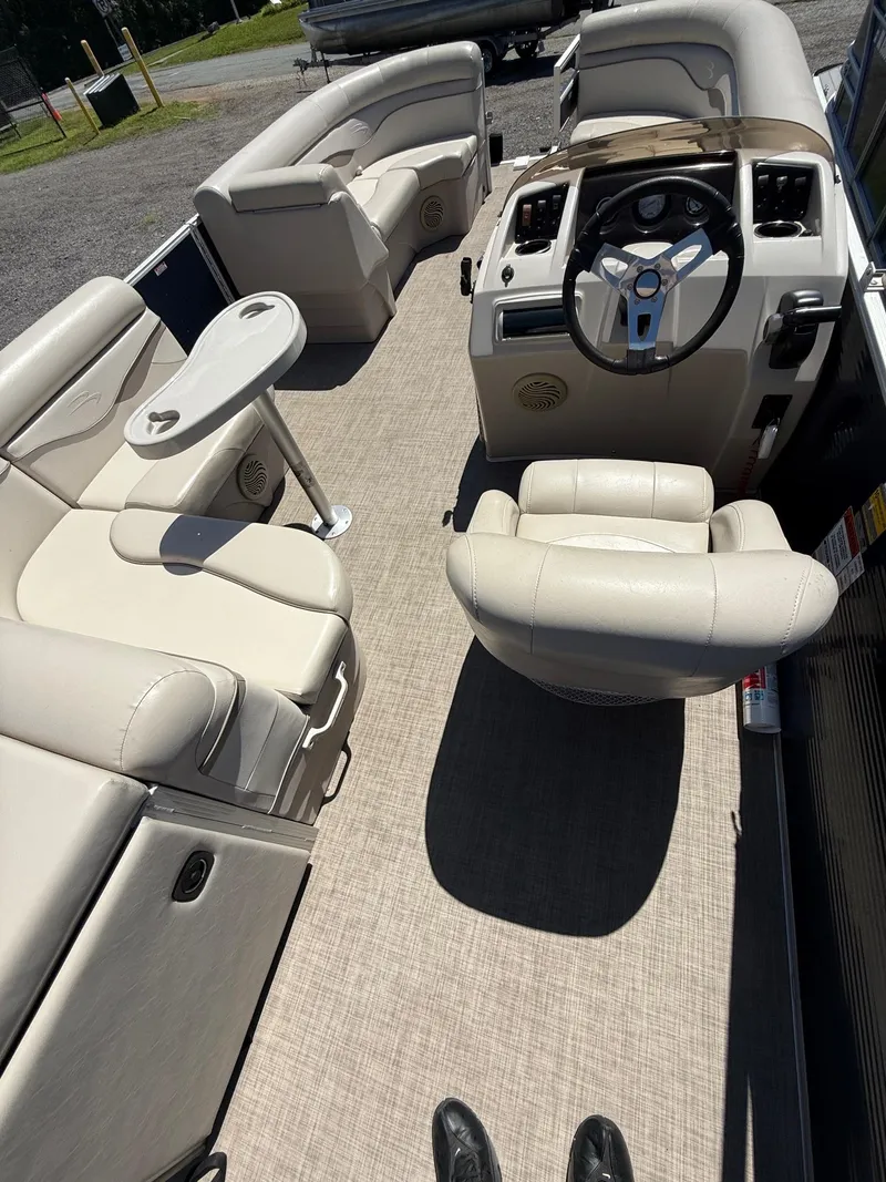 Slide: The Image of 2016 Bennington 22 SX boat interior with beige seating and steering console. - 4