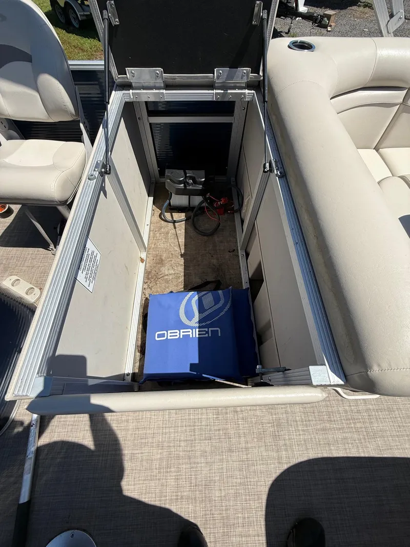 Slide: The Image of Open storage compartment in 2016 Bennington 22 SX boat with O'Brien equipment inside. - 5