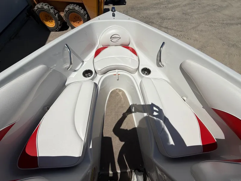 Slide: The Image of 2012 Crownline 18 SS boat interior with white and red seating, cup holders, and handrails. - 10