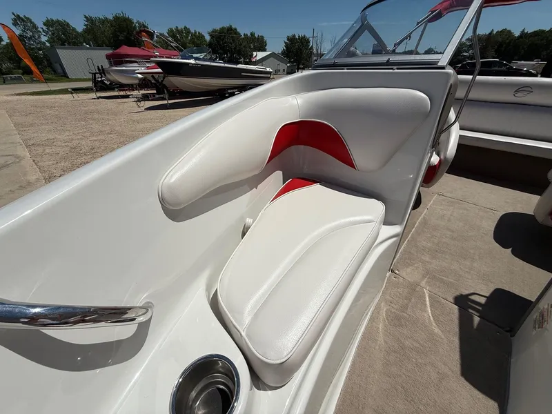 Slide: The Image of 2012 Crownline 18 SS boat interior with white and red seating, cup holder, and windshield. - 11
