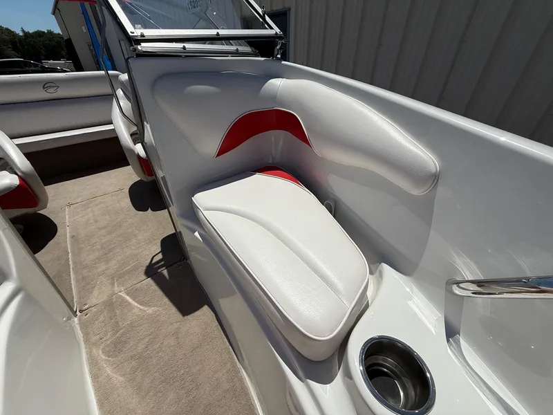 Slide: The Image of 2012 Crownline 18 SS boat interior with white and red seating, cup holder, and carpeted floor. - 12
