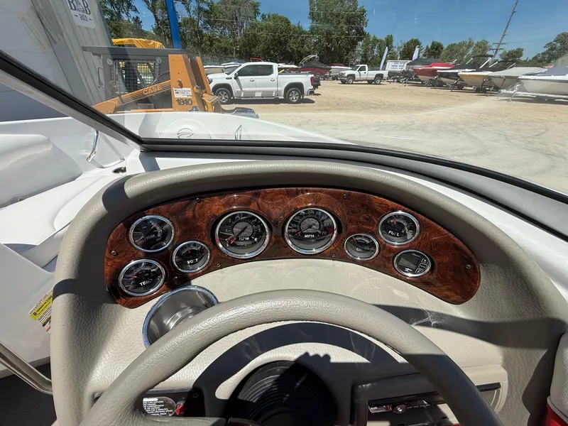Slide: The Image of Dashboard of a 2012 Crownline 18 SS boat with gauges and steering wheel. - 15