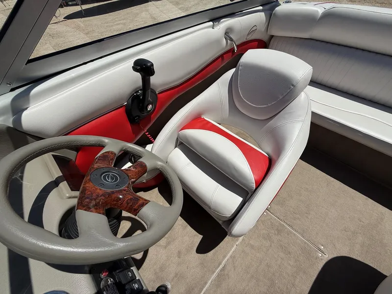 Slide: The Image of Interior of 2012 Crownline 18 SS boat with steering wheel and white-red seating. - 18