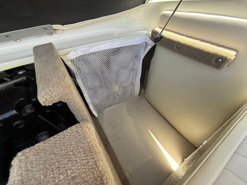 Slide: The Image of Interior of 2012 Crownline 18 SS boat showing storage compartment and netting. - 22
