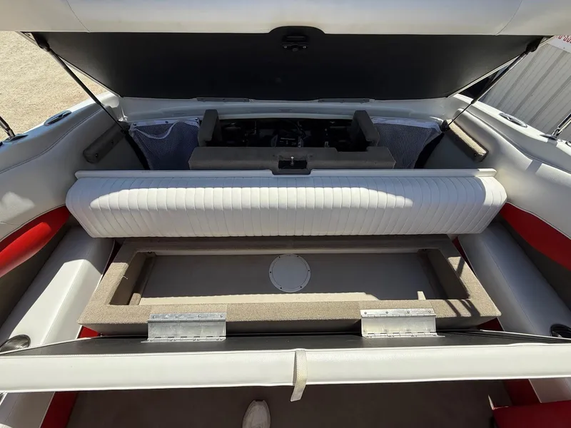 Slide: The Image of 2012 Crownline 18 SS boat interior with open storage compartments and seating. - 24