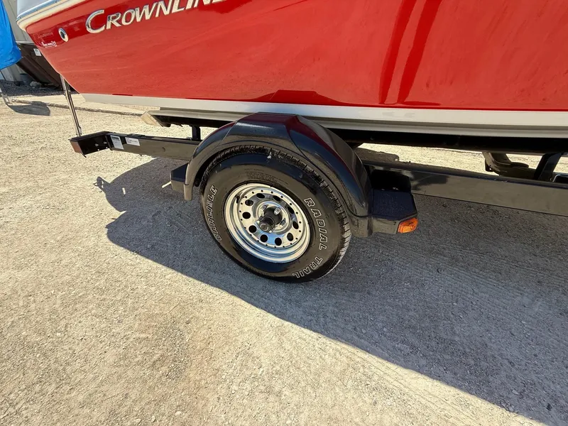 Slide: The Image of Red 2012 Crownline 18 SS boat on trailer, showcasing wheel and hull details. - 25