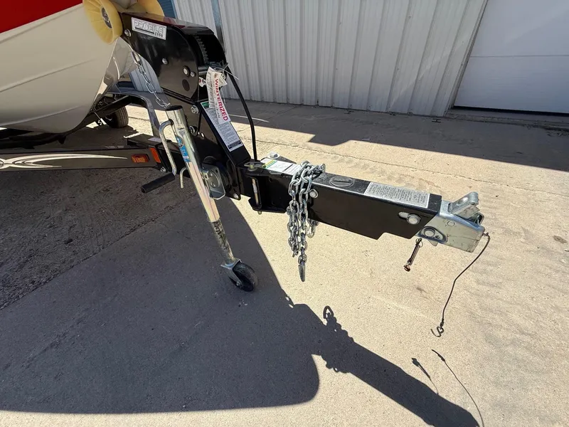 Slide: The Image of Trailer hitch of a 2012 Crownline 18 SS boat, parked on concrete. - 27