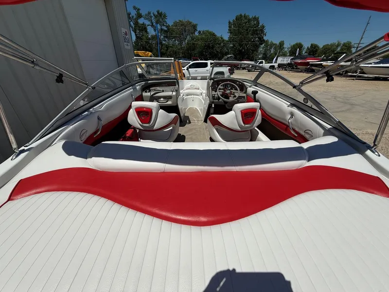 Slide: The Image of 2012 Crownline 18 SS boat interior with red and white seating, steering wheel, and dashboard. - 8