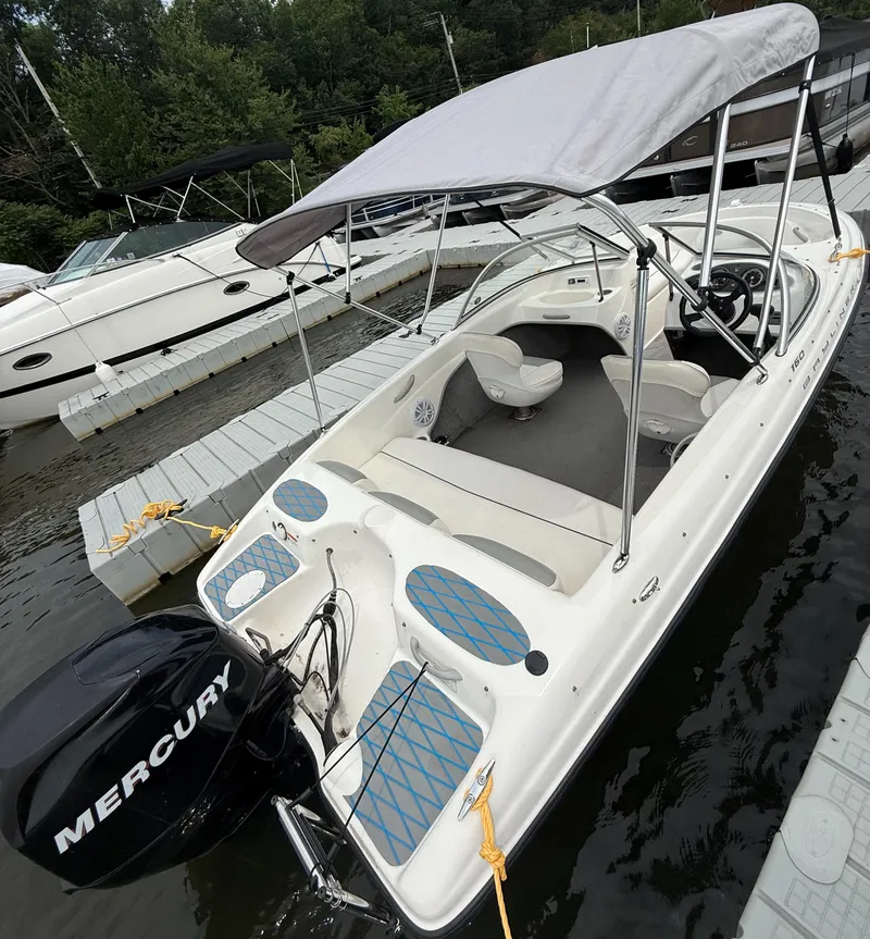Slide: The Image of 2013 Bayliner 160 Bowrider with Mercury engine docked at marina. - 2